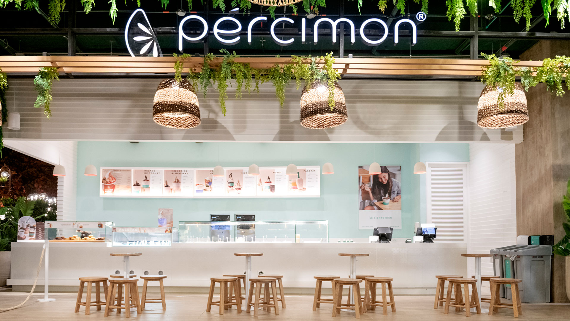 Letrero de neon Pércimon con plantas colgantes